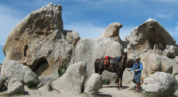 Susan Bates stands in front of Eagle Rock on the Pacific Crest Trail. Photo by Susan Bates