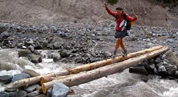 Hiker crossing a log on the Pacific Crest Trail. Photo by Stephanie White