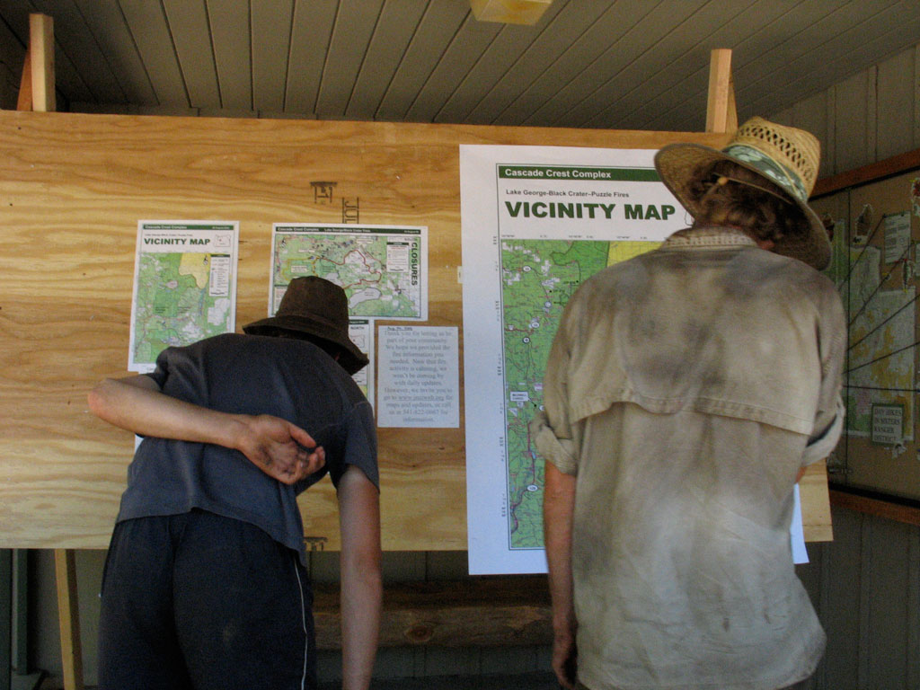 Thruhikers reading information about a fire closure that forced them to skip around. Photo by Jack Haskel
