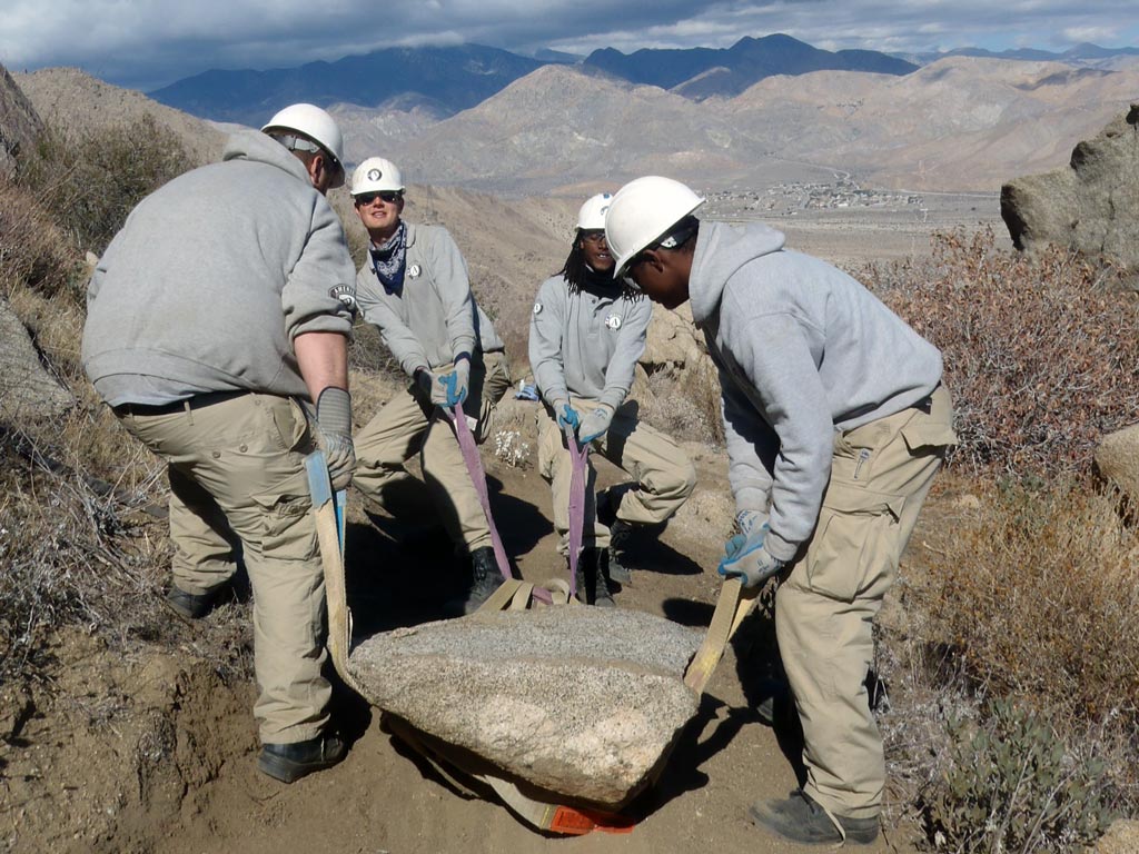 Mike, Peter, Kevin and Rashawn moving a large rock as a team above Snow Creek.