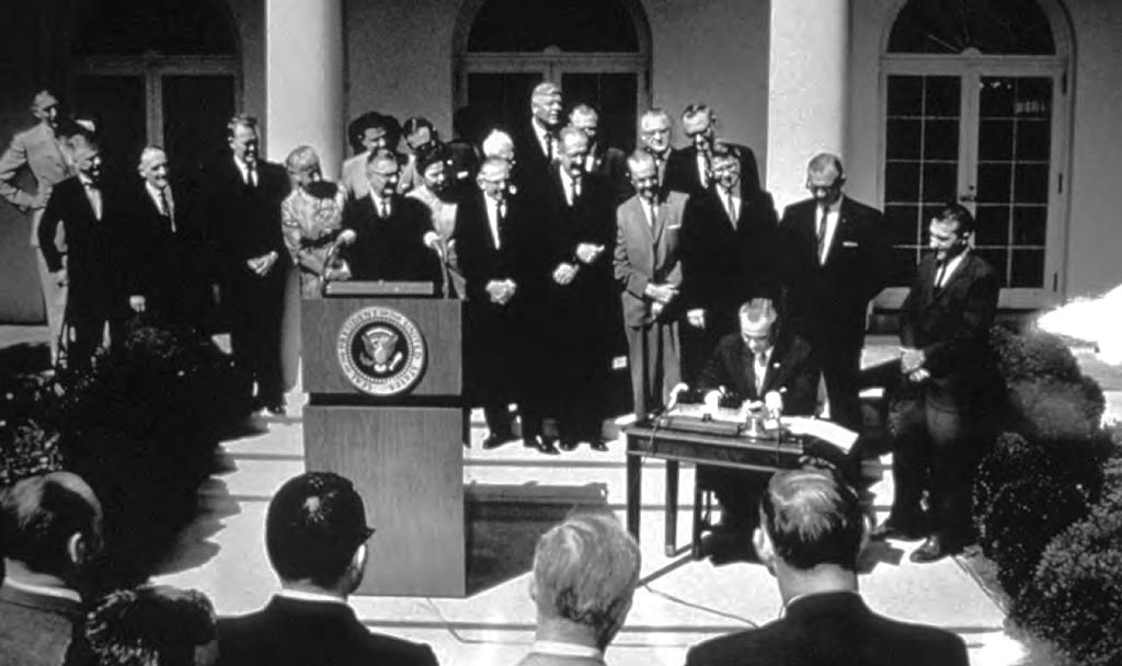 President Lyndon Johnson signs the Wilderness Act into law. Photo via the Library of Congress.