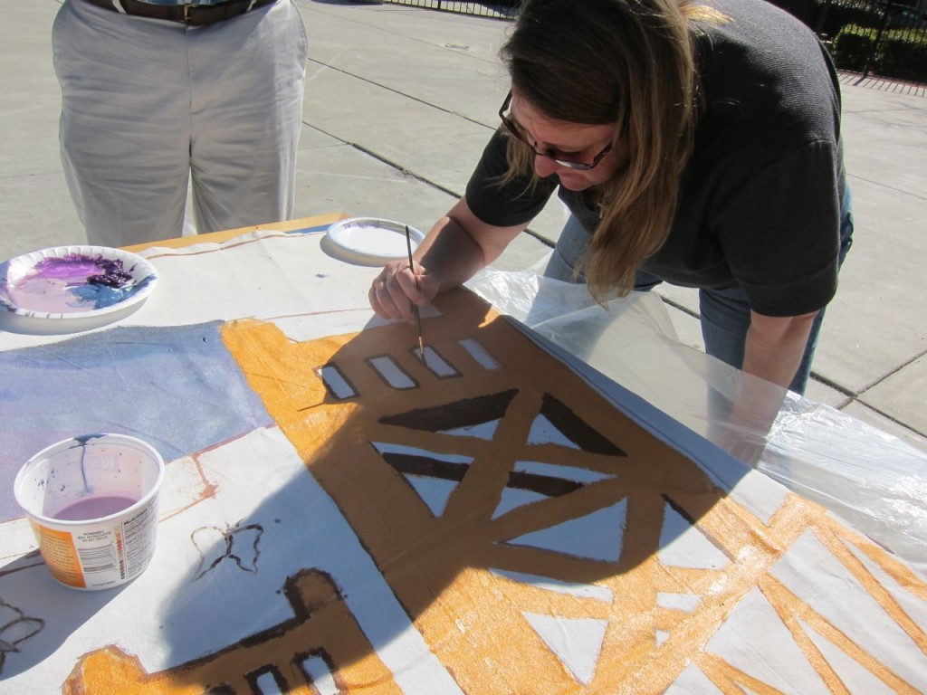 Beth Southorn, of LifeSTEPS, paints Sacramento's Tower Bridge.