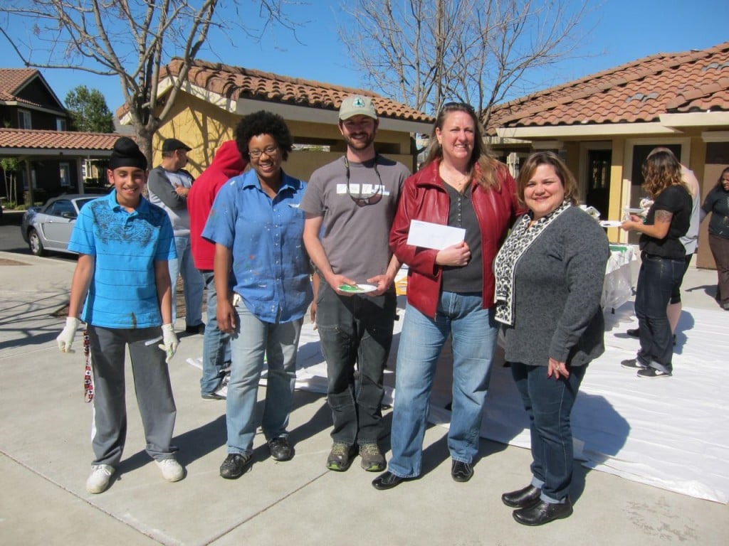 The staff team for the mural project. From left to right: one of the students, the muralist, Jack Haskel (PCTA). Beth Southorn (LifeSTEPS), a representative from the bank that donated funds for the project.
