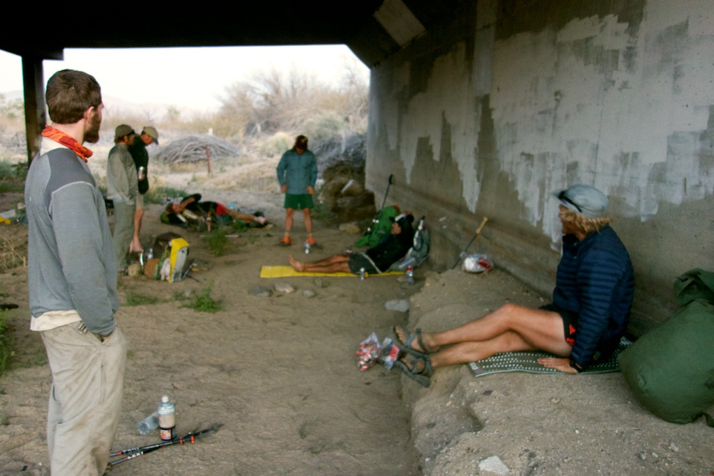 Thru-hikers wait out the mid day sun under a bridge in Scissors crossing. Southern California