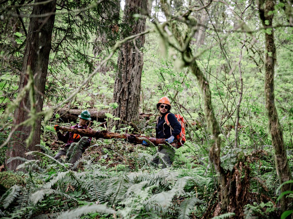 Trail crew volunteers moving a log in Oregon. Photo: Gray Feather Photography.