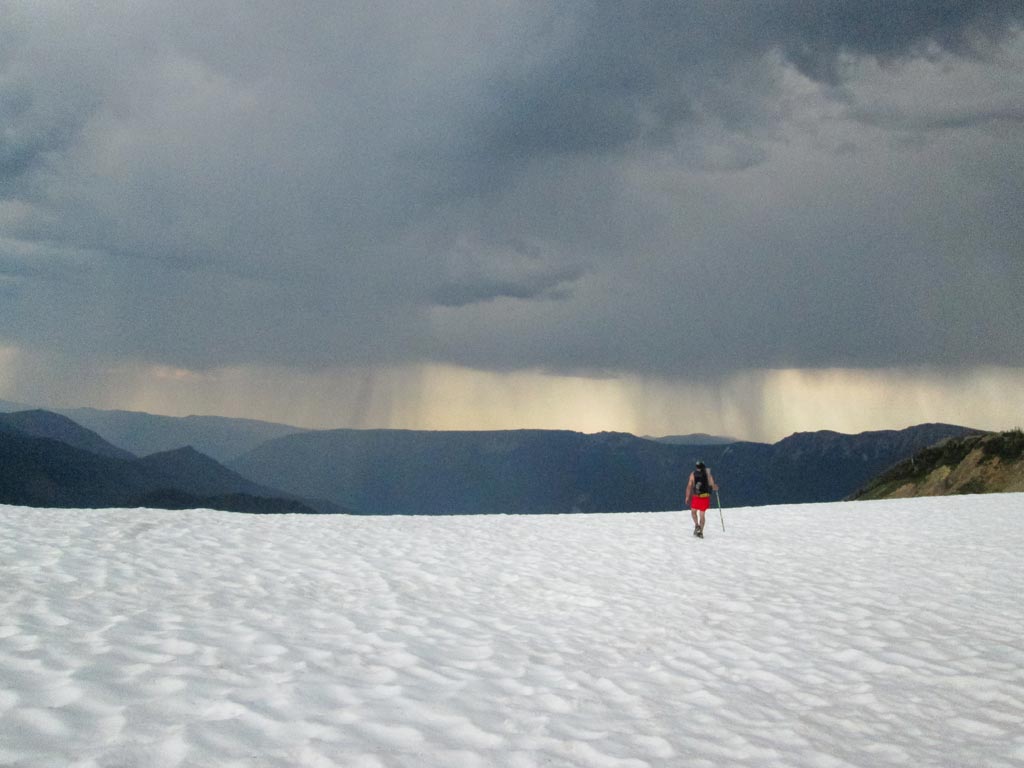 'Oakdale' passes McCall glacier in Goat Rocks Wilderness, with a storm looming in the distance. Photo by: Ashley Ross