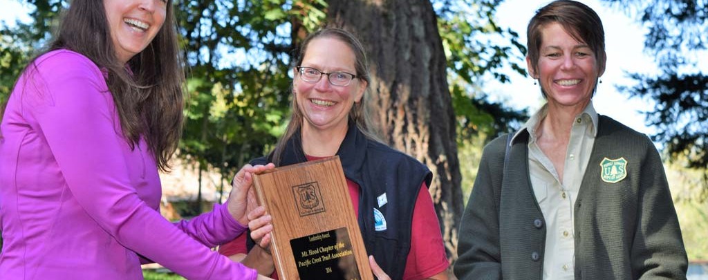 Jennifer Wade & Lisa Northrop present the 2014 Forest Service Volunteers & Service Leadership Award to Mt. Hood Chapter Chair, Roberta Cobb. Photo by Liz Marriott