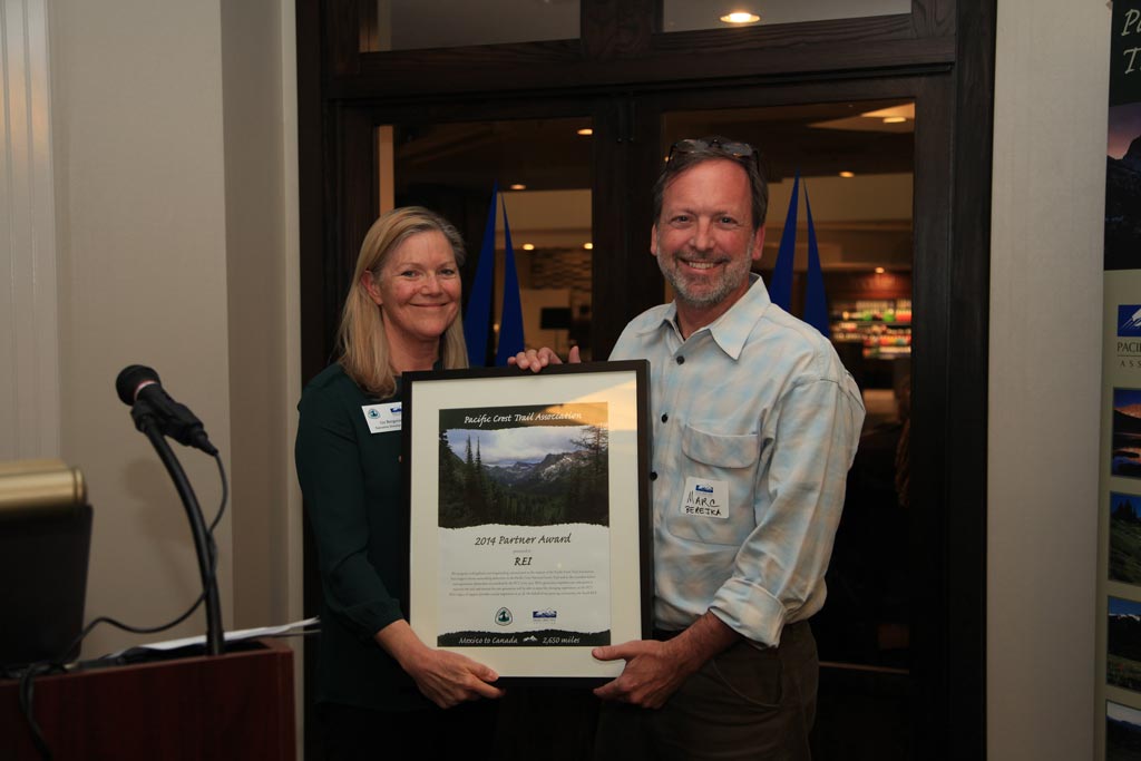 Marc Berejka, REI's Director of Community and Government Affairs, receives an award on behalf of REI.