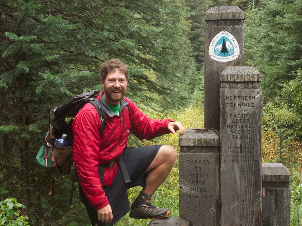 Colin Arisman at the northern terminus of the Pacific Crest Trail.