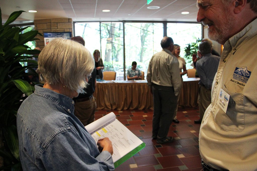 Alice Tulloch and John Hoffnagle discuss trail registers before the annual meeting.