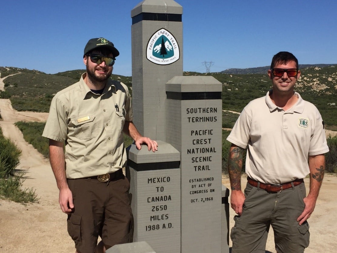 The Crest Runners stand at the Southern Terminus of the Pacific Crest Trail. They work for Cleveland National Forest.