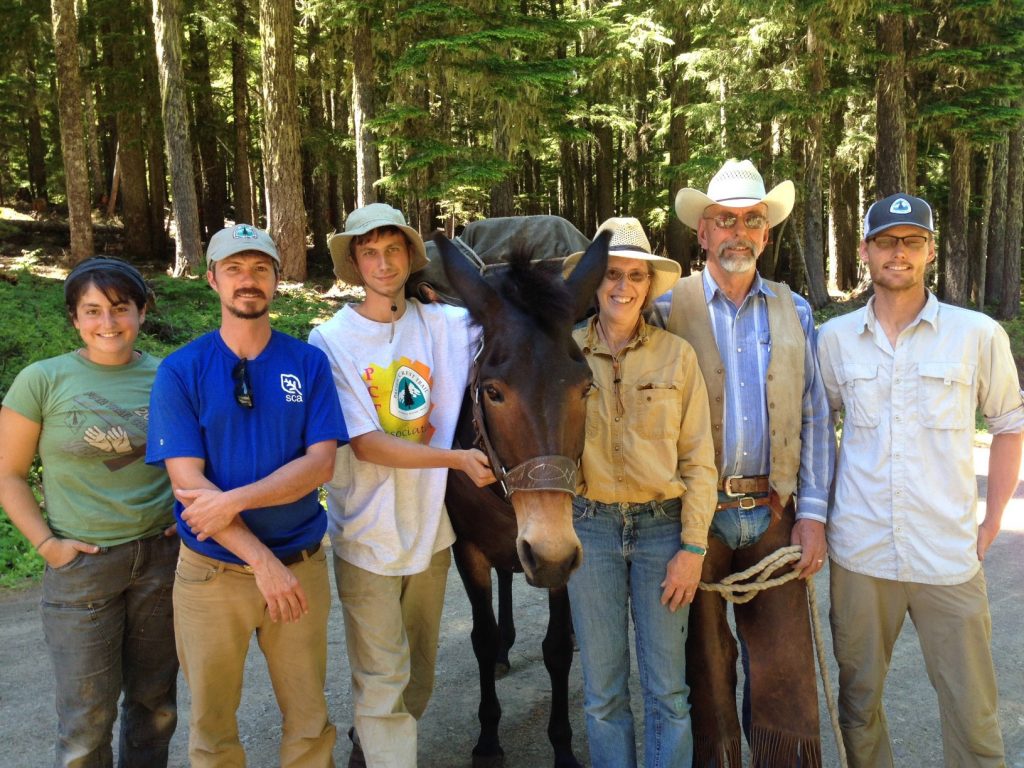 Jennica Tamler, Justin Brimer, Ian Connelly, Snickers, Sue Forsman, Jim Forsman, and Wes Jones gather for a training in the art of working with packers and pack stock.