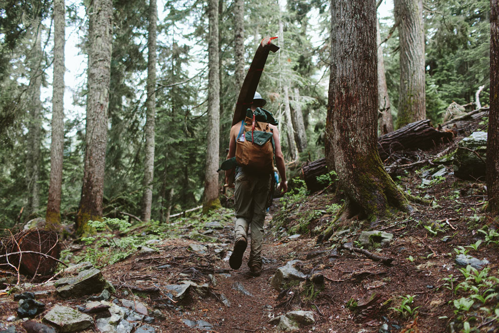 A volunteer heads to work with a crosscut saw in Washington state. Join PCTA on a volunteer trail crew. Photo by Vincent Carabeo/Uphill Designs.