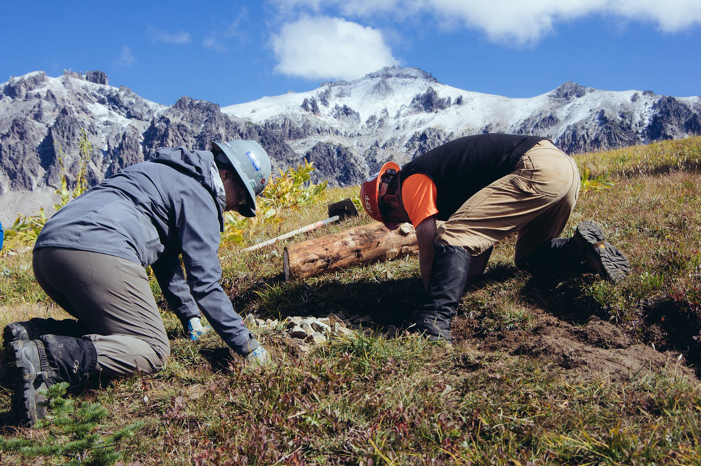 Setting sign posts at Yakima Pass with fresh snow in the high elevation parts of Goat Rocks Wilderness. Photo by Liz Donovan.