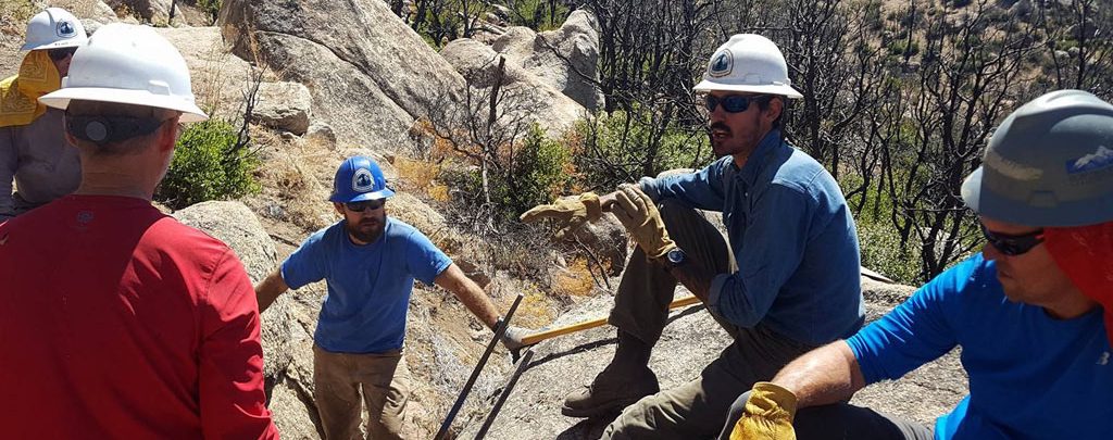 Training volunteers on proper rock bar technique. Photo by Mike Lewis.