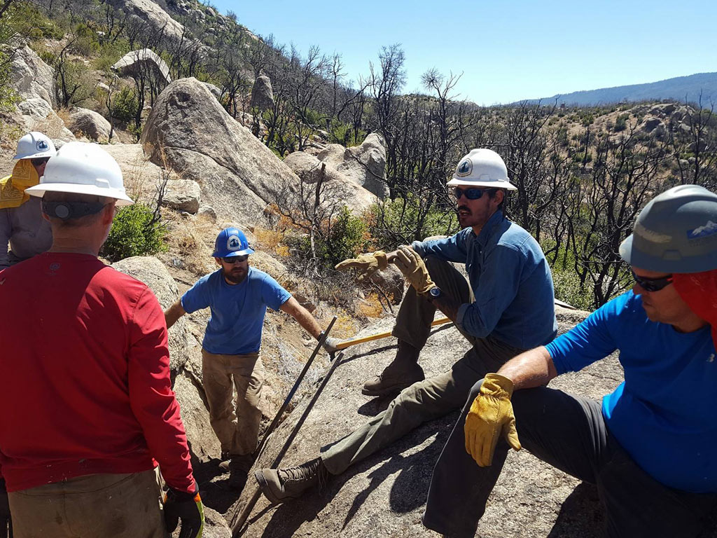 Training volunteers on proper rock bar technique. Photo by Mike Lewis.