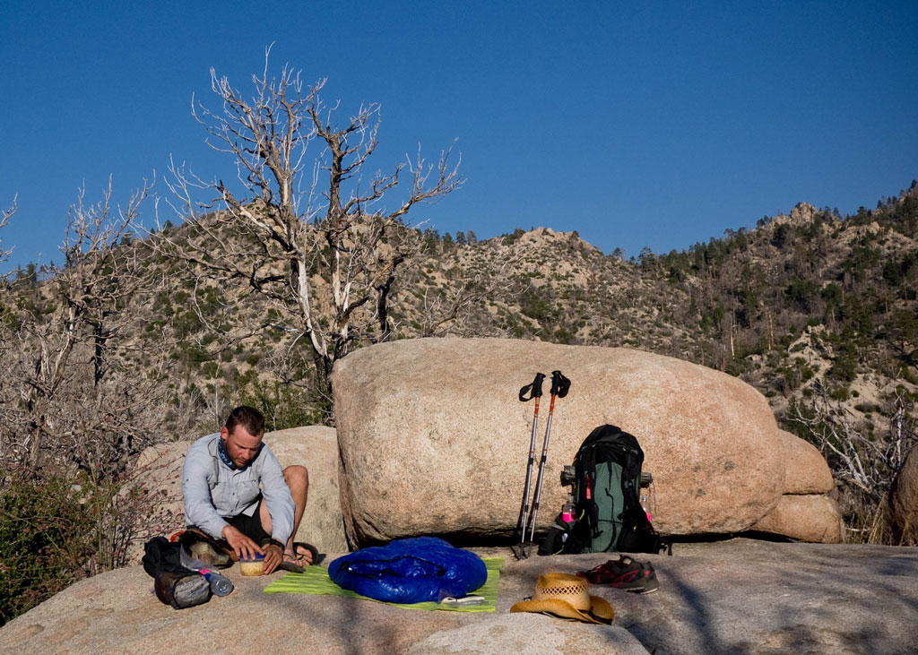 A thru-hiker makes camp on a durable surface: a boulder. He won't be leaving compacted soil, damaged plants or an obvious camp behind. Photo by Ethan Gehl