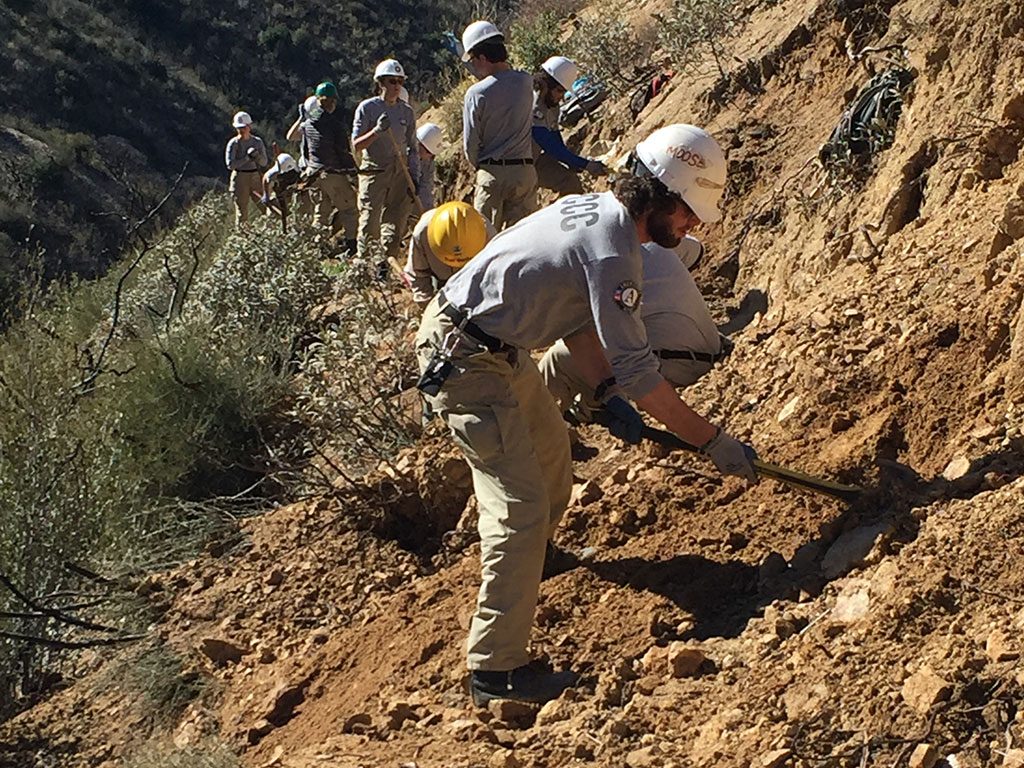 AmeriCorps NCCC crew re-benching a section of damaged trail. Photo by Connor Swift.