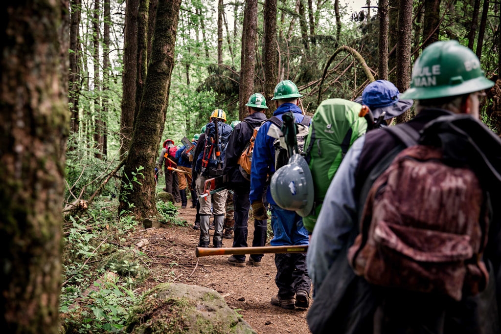 Volunteers learn how to use crosscut sawsto help keep the PCT open during our 2016 Trail Skills College in the Columbia River Gorge. Photo by Gray Feather Photography