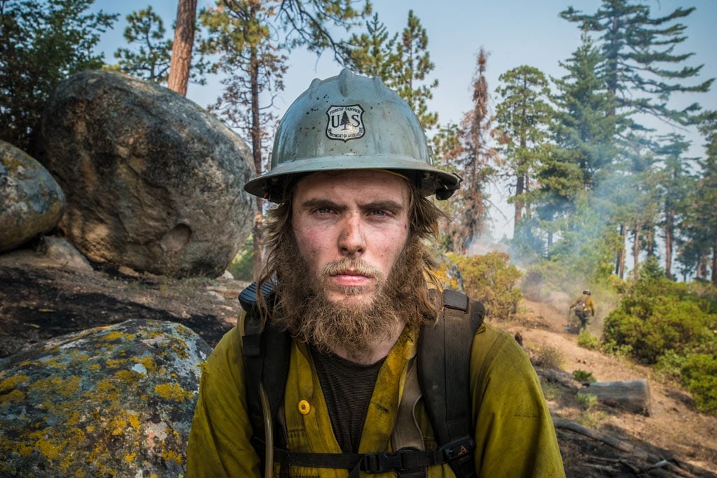 Forest Service Smith River Hotshots Forestry Technician, Shane Blair is part of an army of wildland fire fighters on the front line of our nation’s response. Here is works to clear hazard trees during a fire on Sequoia National Forest, August 23, 2016. USDA Photo by Lance Cheung.