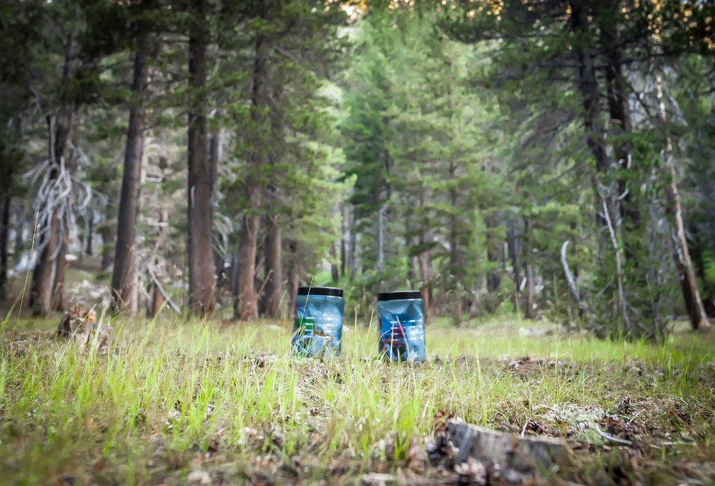 Bear canisters set out for the night away from camp. Photo by Martin Christian