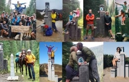 PCT alumni thruhikers standing at the northern terminus on the Canadian border