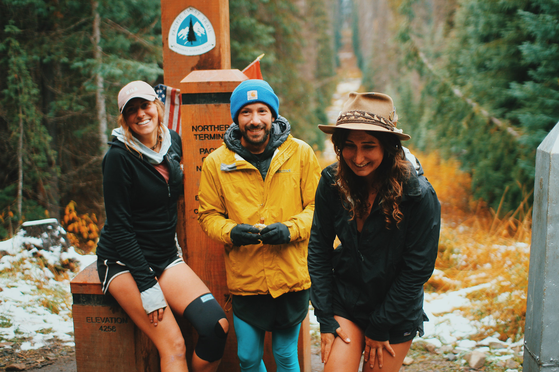 Blue, Twerk and Rumi standing at the Northern Terminus of the Pacific Crest Trail after walking a really long way. Photo courtesy of Tommy Corey.